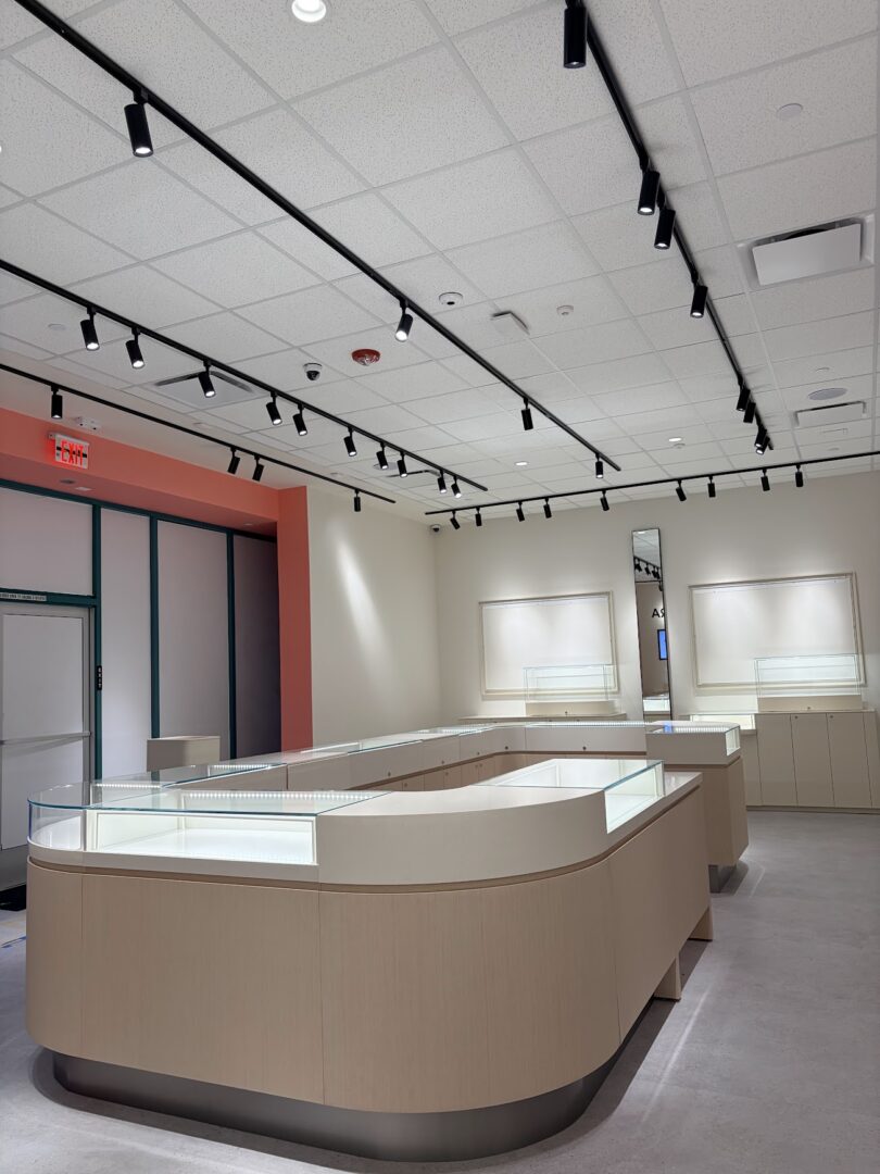Modern museum exhibit room with display cases and minimalist design.